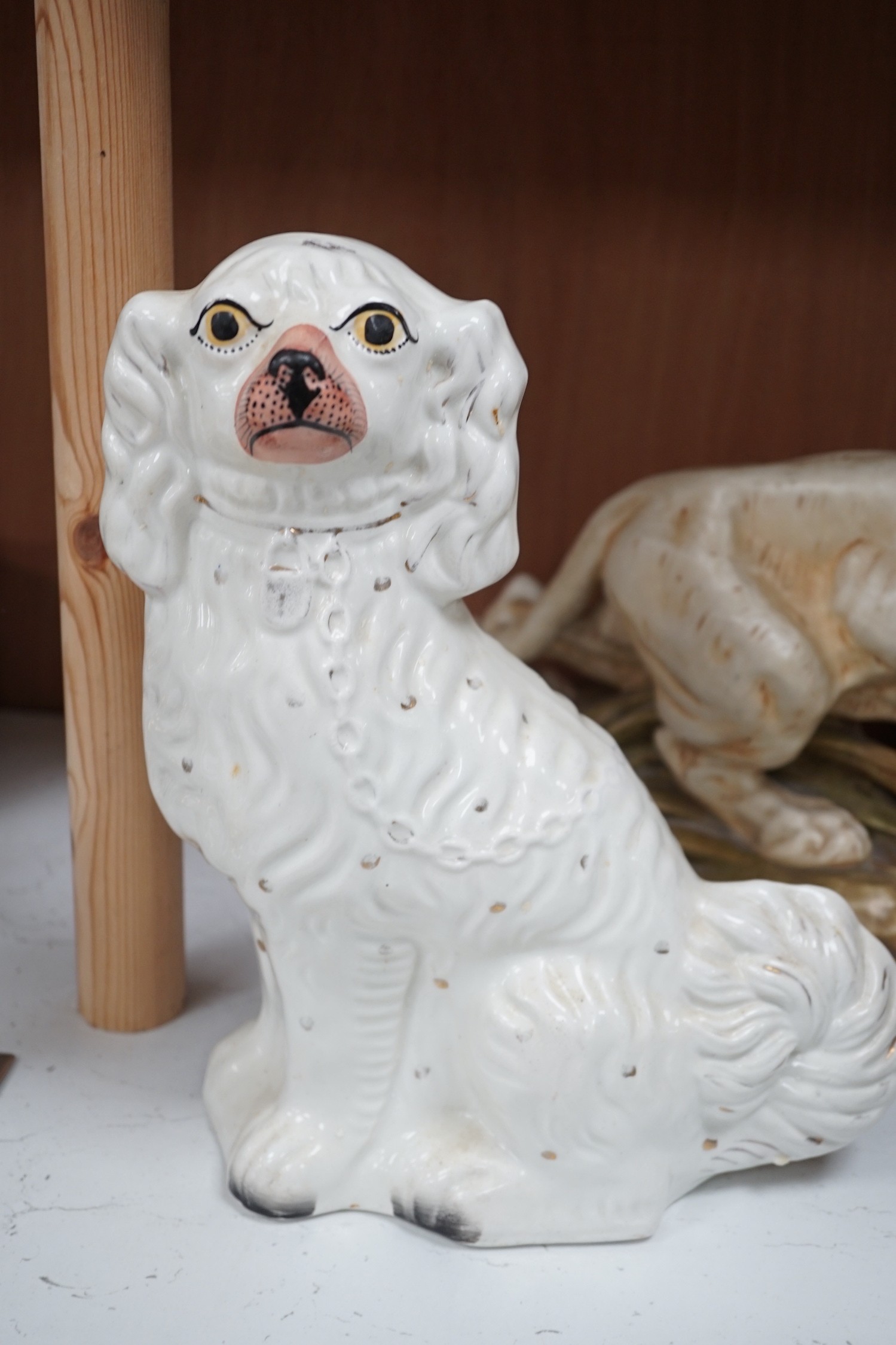 A Royal Dux tiger, a pair of Staffordshire Spaniels and a figural flat back, tiger 28cms high